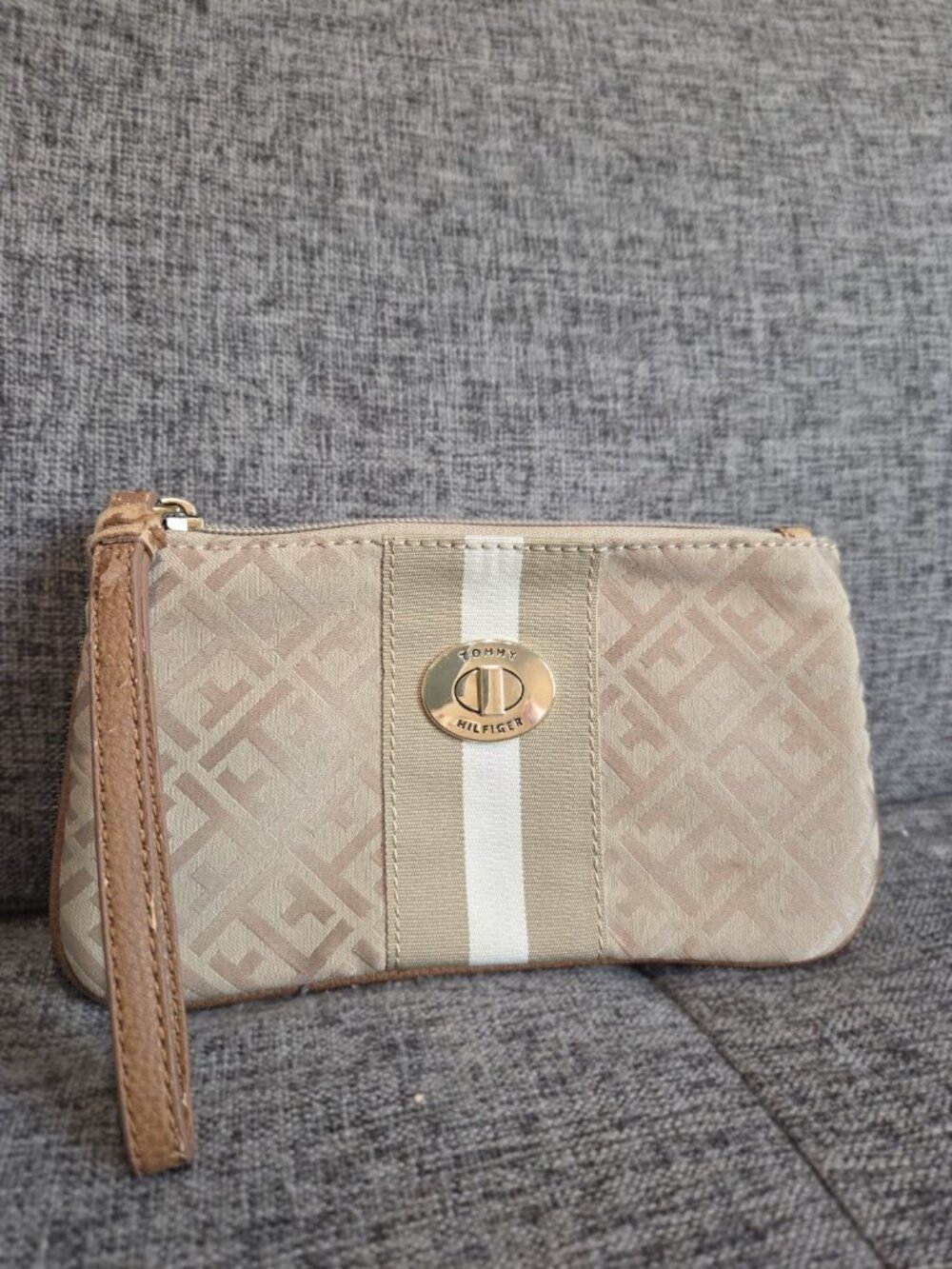 beige Tommy Hilfiger logo-print wristlet pouch with a central striped accent and